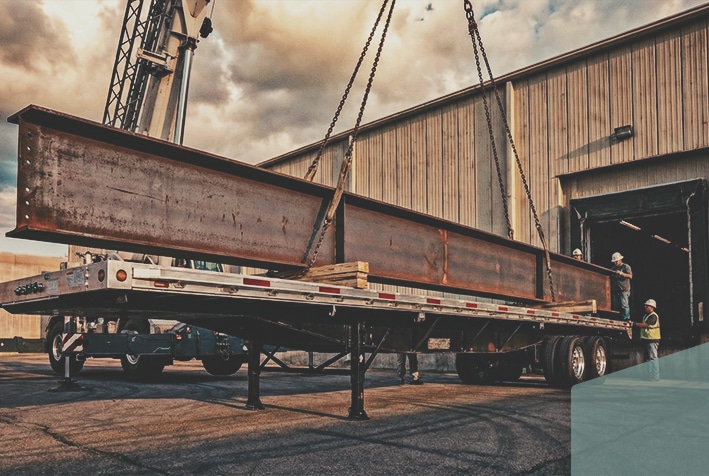 flatbed trailer unloading large load